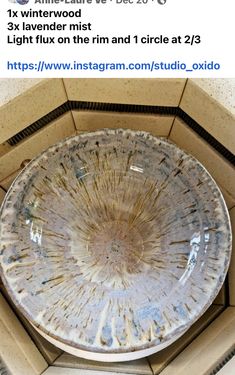 an old glass bowl sitting on top of a table