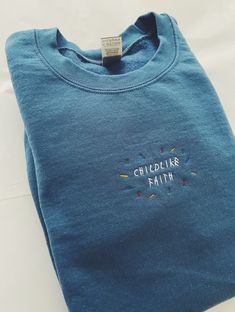 Our 'Childlike Faith' embroidered sweatshirt is made with air-jet spun yarn for a soft and comfy fit. Unisex fit. #christianembroideredsweatshirt #christianaesthetic #christianshirt #christianSweatshirt #cuteChristianSweatshirt #biblesweatshirt #trendychristiansweatshirt #faithsweatshirt #faithclothing #aestheticchristian #ChristianApparel #ChristianHoodie #Jesussweatshirt #Jesusshirt #faithapparel #Christiangift #Christiangiftforfriend #cutesweatshirt #embroideredsweatshirt #faithapparel #faith Embroidered Christian Clothing, Christian Sweatshirts Hoodie, Aesthetic Christian Sweatshirts, Small Business Sweatshirt, Aesthetic Christian Clothes, Christian Apparel Aesthetic, Christian Embroidery Designs Shirt, Christian Embroidered Sweatshirt, Cool Sweatshirt Designs