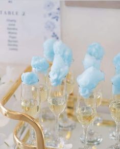 there are many champagne glasses with blue frosting on them