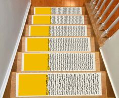 the stairs are painted yellow and white with black polka dots on each one side, along with matching rugs