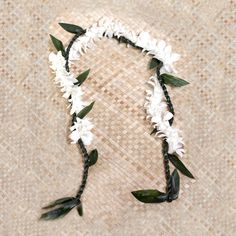 a white flower crown with green leaves