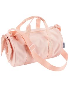 a pink duffel bag with a bow on the front and shoulder strap around it