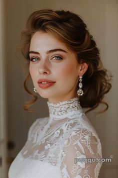 a woman wearing a white dress and earrings