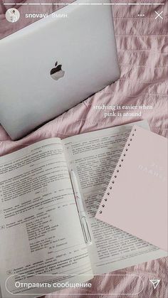 an open book next to a laptop computer on top of a pink bed spread with text