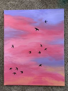 a painting of birds flying in the sky at sunset or dawn with pink and blue clouds