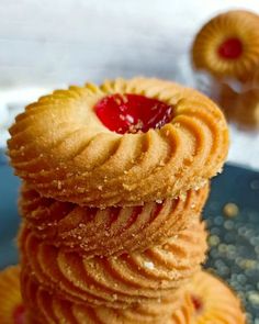 several cookies stacked on top of each other with jelly in the middle and one being eaten