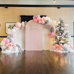 a decorated stage with balloons and trees