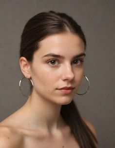 a woman with large hoop earrings on her face