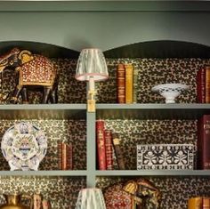 the bookshelf is filled with many different items and decorative objects, including vases