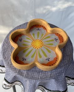 a flower shaped bowl sitting on top of a chair