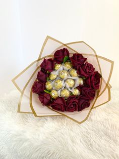 a bouquet of roses with chocolates in it