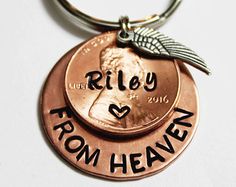 a penny keychain with the words riley and from heaven on it is shown