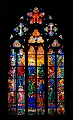 a large stained glass window in a dark room