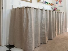 a row of drapes sitting next to each other in front of a doorway with pictures on the wall