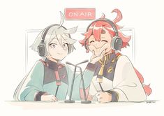 two people sitting at a table with headphones on and one is listening to the other