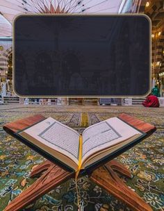 an open book sitting on top of a carpet in front of a large signboard