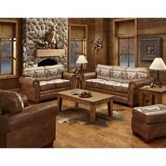 a living room with couches, chairs and tables in front of a stone fireplace