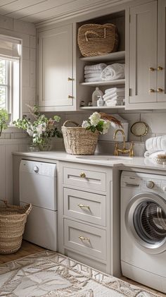 a washer and dryer in a small room with white walls, cabinets and drawers