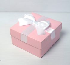 a pink box with a white bow on it