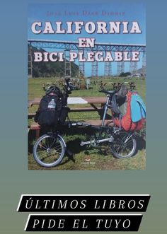 a bike with a backpack on the back parked next to a picnic table