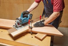 a man using a power tool to cut wood