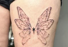 a woman's thigh with a butterfly tattoo on it