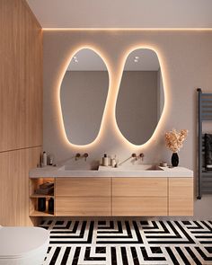 a modern bathroom with two oval mirrors above the sinks