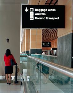 the woman is waiting for her luggage at the airport