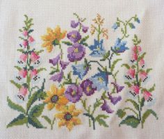 a cross stitch pattern with flowers on it