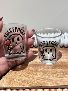 two shot glasses with ghost faces on them