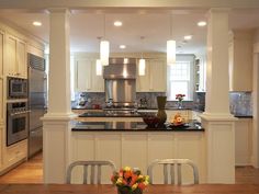 a kitchen with white cabinets and an island