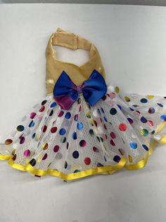 a dress made out of mesh and polka dots with a blue bow on the top