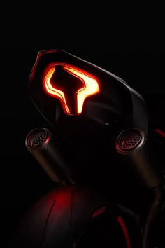 a close up of a motorcycle with its lights on and the tail light turned red