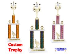 three trophies are shown with the words custom trophy written below them in red, white, and blue