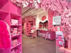 a store with pink walls and shelves filled with items