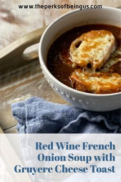 red wine - french onion soup with gruyer cheese toast in a white bowl