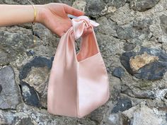 🔘 This Elegant Satin knot bag is ideal for the wedding day, night out, party, special occasion, brides, bridesmaids, mothers of the bride, or any formal fun 🔘 This  bag has an elastic opening and a stiff bottom   🔘 Please contact us for a custom order. 🔘 Material: Satin fabric or faux Silk. The lining fabric is the same fabric as on the outside. This bag has a magnetic snap closure inside. It also has a bottom shaper inside. 🔘 Measurements: Bottom Length x Height x Depth; 16 x 16 x 10 cm / Formal Purse Evening Bags, Satin Pouch Bag, Elegant Evening Bag With Satin Bow, Elegant Evening Bags With Satin Bow, Rectangular Satin Wedding Bag, Elegant Wedding Bags With Bow Detail, Elegant Wedding Bags With Bow, Elegant Shoulder Bag With Bow As A Gift, Chic Satin Evening Bag For Wedding