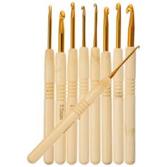 six wooden crochet hooks with gold colored handles and tips, all lined up in a row