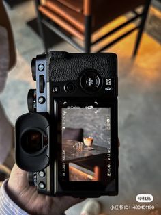 a person is holding up a camera to take a photo with the image on it