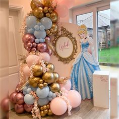 there is a tree made out of balloons and other items in front of the door