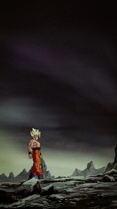 a person standing on top of a snow covered slope under a dark sky with mountains in the background