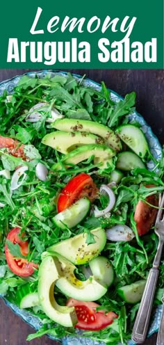 a salad with avocado, tomatoes and spinach on it in a bowl