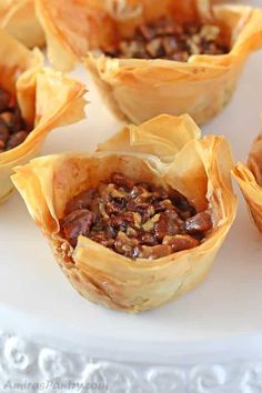 baked desserts are sitting on a white plate