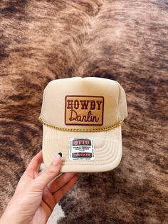 Introducing the "Howdy Darlin" trucker hat in tan, a stylish and practical accessory for any occasion. This hat is perfect for those who want to add a touch of personality to their outfit while also keeping the sun out of their eyes. The patch and hat chain design is trendy and fashionable, making it a great addition to any wardrobe. Whether you're going for a casual look or need a hat for a specific occasion, the "Howdy Darlin" trucker hat is a great choice. It's perfect for outdoor activities, such as hiking or camping, or for everyday wear. Plus, it makes a great gift for friends and family who love to accessorize. So why wait? Order your "Howdy Darlin" trucker hat today and add a touch of style and practicality to your wardrobe. Hat Chain, Chain Design, Terry Cloth, Trucker Cap, Outdoor Activities, Caps Hats, Trucker Hat, Casual Looks, Gifts For Friends