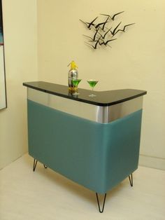 a blue and chrome bar in the corner of a room