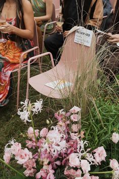 people sitting in lawn chairs with flowers around them