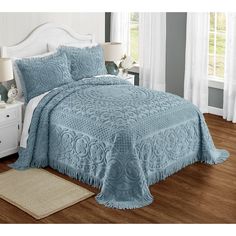 a bed with a blue bedspread and pillows