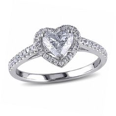 a heart shaped diamond ring with diamonds on the band and shoulders, set in 18k white gold