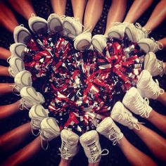 a group of people standing around each other with their feet in the middle of them