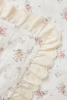 an old fashioned crochet doily is laying on top of a white sheet